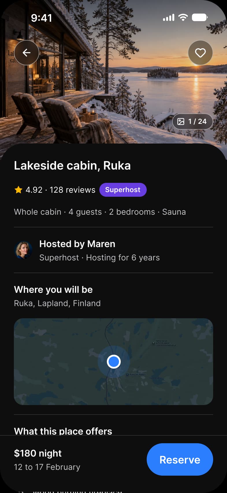 Booking app Listing screen in dark mode: a full-bleed cabin photo with back and favorite buttons and a 1 of 24 count, Lakeside cabin in Ruka rated 4.92 from 128 reviews with a Superhost badge, host Maren, a map, amenities, and a bar with $180 night and a Reserve button