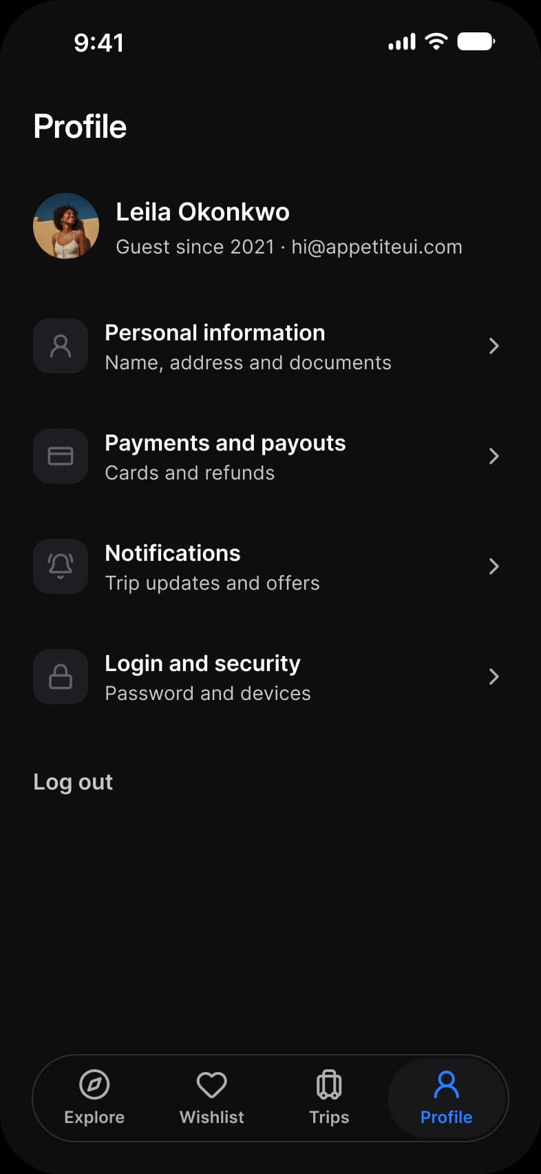 Booking app Profile screen in dark mode: Leila Okonkwo with her photo, four rows for Personal information, Payments and payouts, Notifications and Login and security, and a Log out button above a floating tab bar