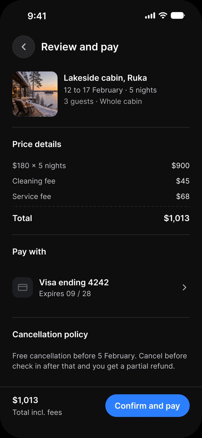 Booking app Review and pay screen in dark mode: the Lakeside cabin stay for 12 to 17 February, a price breakdown of $900, $45 and $68 that totals $1,013, a Visa ending 4242 row, the cancellation policy, and a Confirm and pay button
