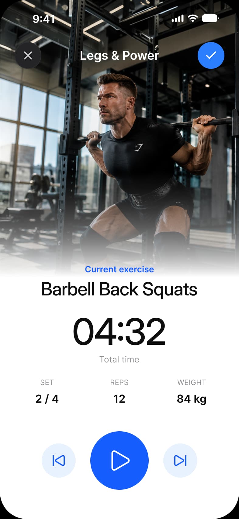 Fitness app Exercise screen: a full height photo of a barbell back squat under a Legs and Power title with close and confirm buttons, Barbell Back Squats as the current exercise, a 04:32 timer, set 2 of 4, 12 reps, 84 kg, and previous, play and next controls