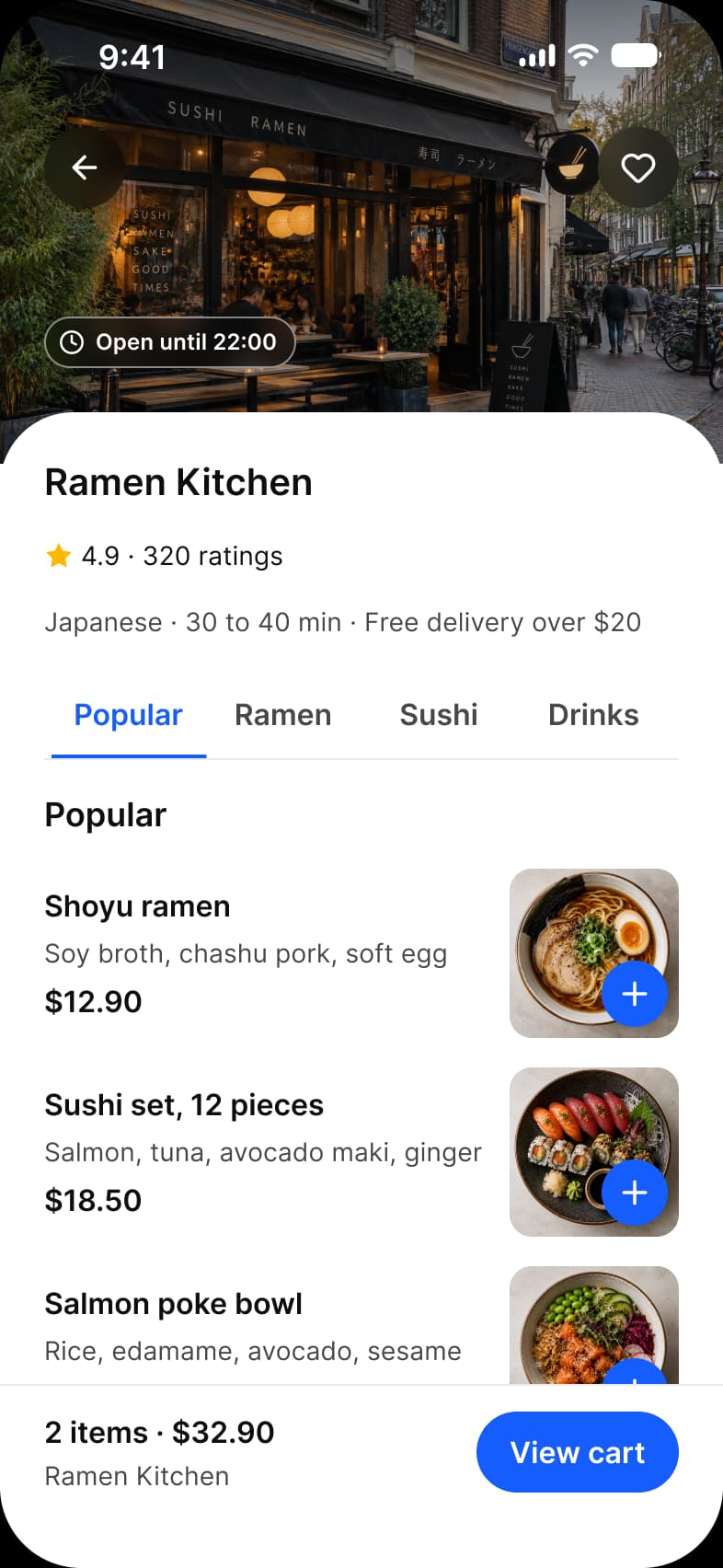 Foodie app Restaurant screen: the Ramen Kitchen storefront photo with back and favorite buttons and an Open until 22:00 label, a 4.9 rating from 320 ratings, Popular, Ramen, Sushi and Drinks tabs, dish rows with a price and a blue add button on each photo, and a View cart bar with 2 items and $32.90